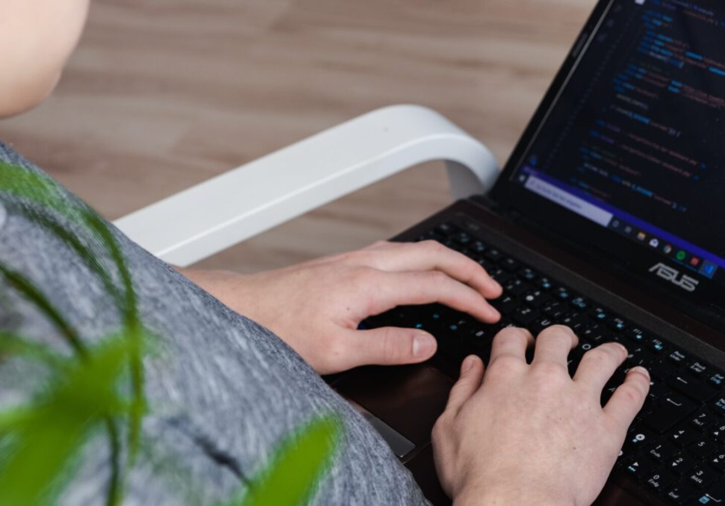 person using black Asus laptop