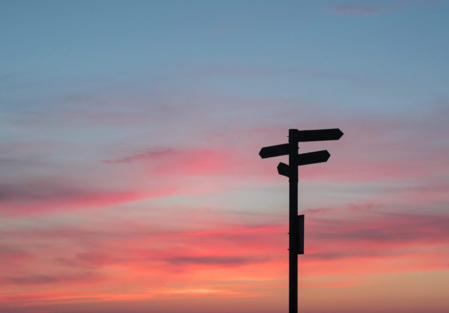 Photo by Javier Allegue Barros silhouette of road signage during golden hour