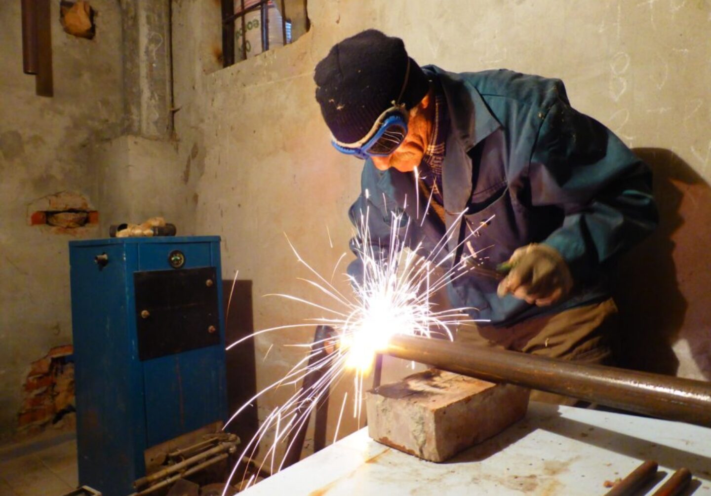 Photo by Kemal Kozbaev man in black jacket holding lighted sparkler