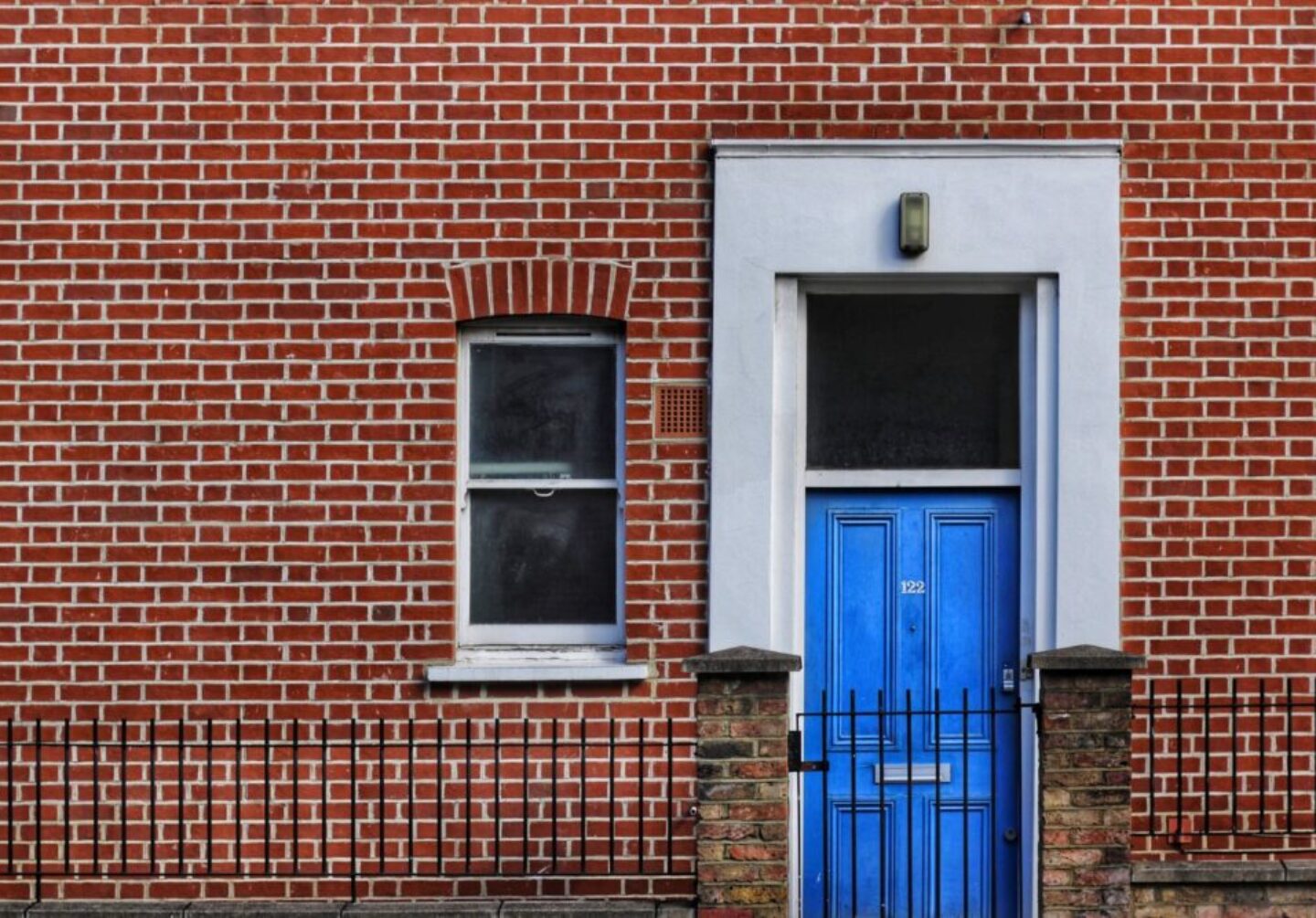 Photo by Max Williams red brick building with closed door and window